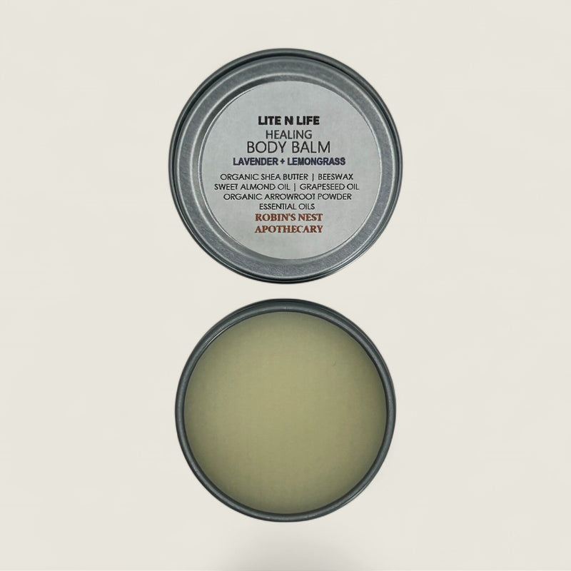 Body balm container with lid open on a light gray background