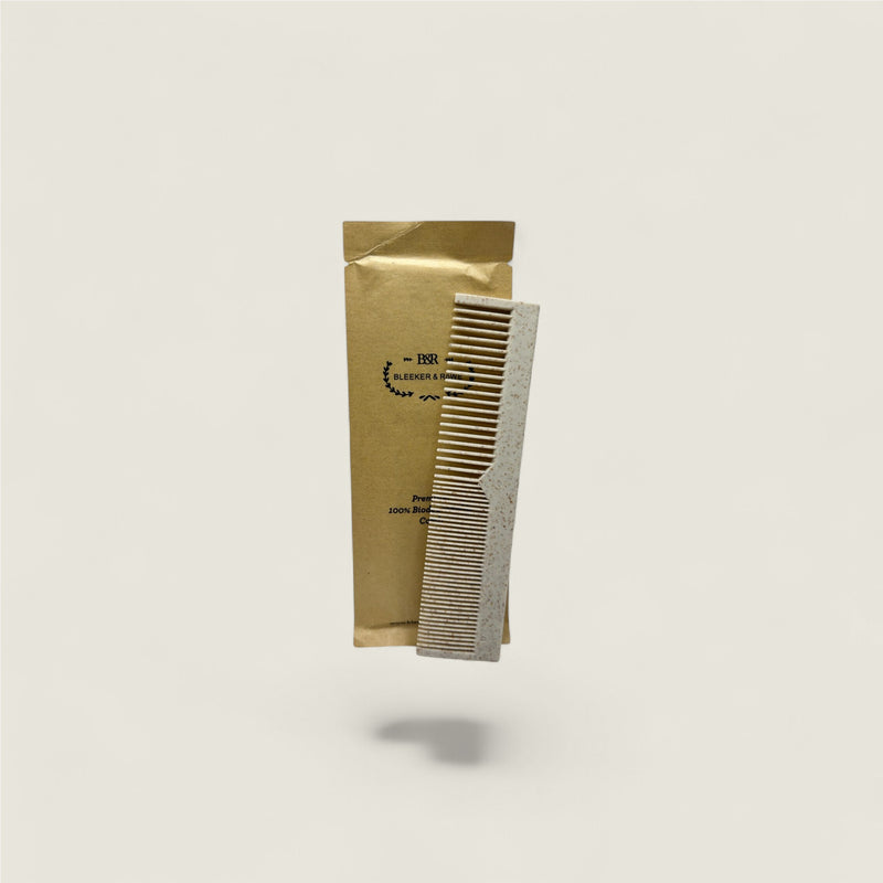 Comb and packaging on a light gray background