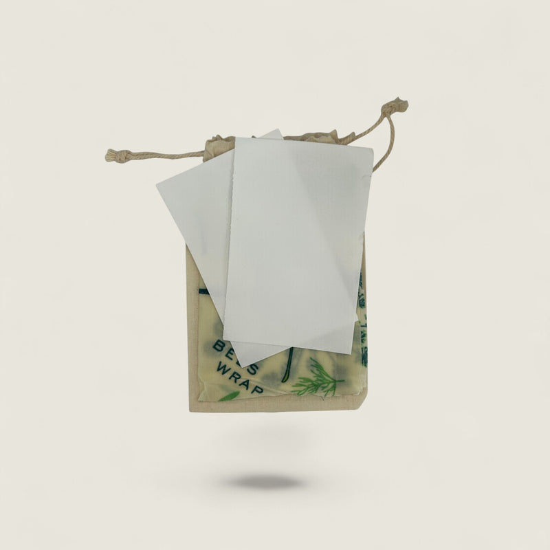 Beeswax wrap with a drawstring bag on a light gray background