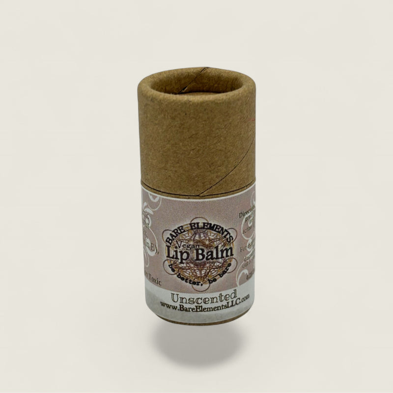 Lip balm in a cardboard tube with a label on a light gray background