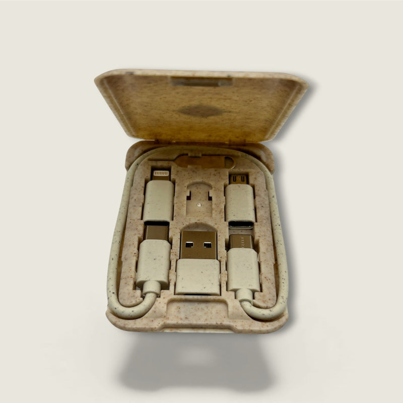 Set of USB cables and connectors in a cardboard box on a light gray background