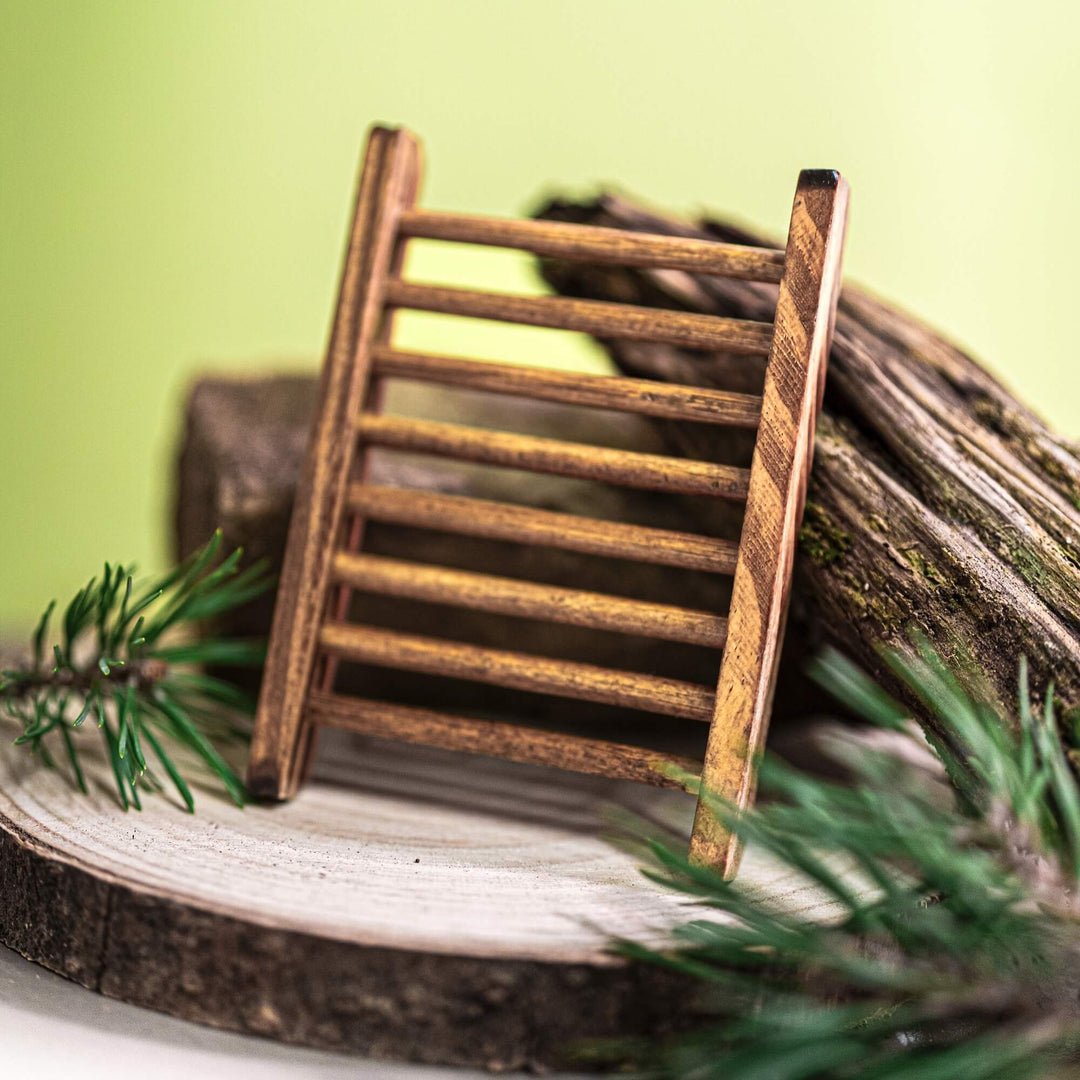 Pinewood soap holder ladder model on a wooden surface with greenery