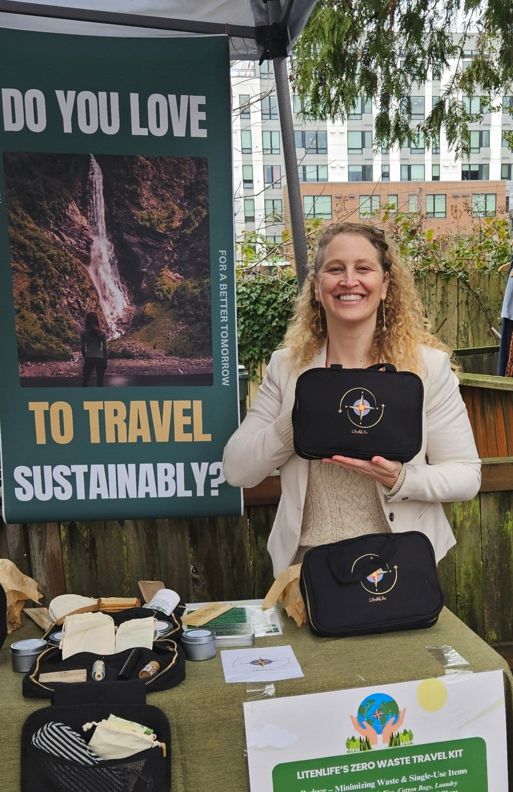 Woman holding a Lite n Life travel kit at an event with promotional materials in the background.