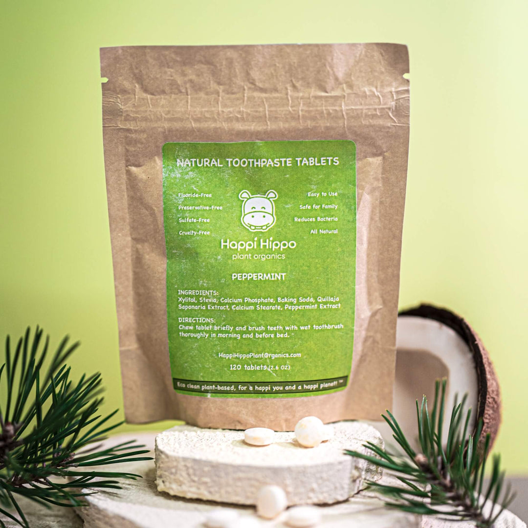 Happi Hippo natural toothpaste tablets packaging with peppermint flavor on a green background